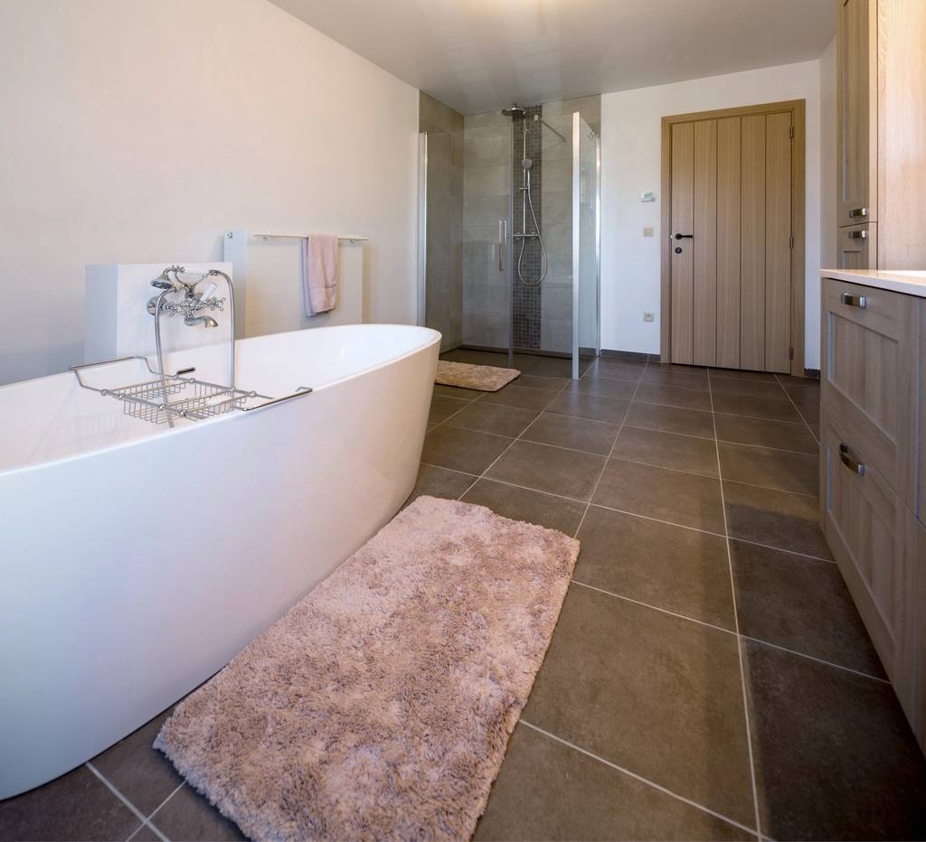 Modern washroom with freestanding tub and tiled floor